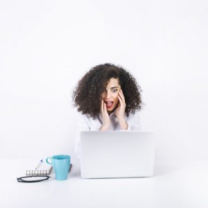Designed by Freepik Image of a person working on a laptop looking surprised